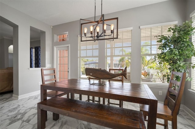 dining area with arched walkways, baseboards, marble finish floor, and a chandelier