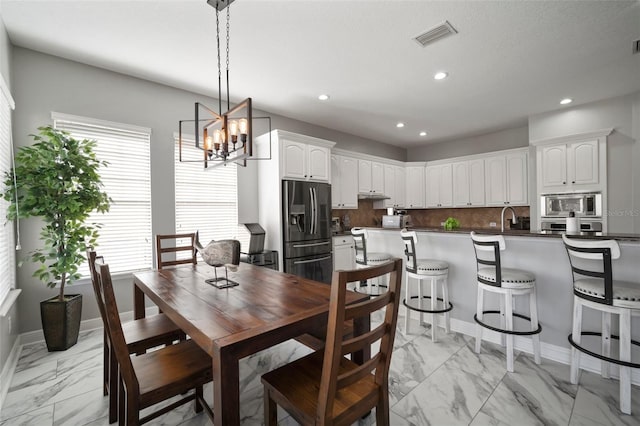 dining room featuring visible vents, baseboards, recessed lighting, an inviting chandelier, and marble finish floor