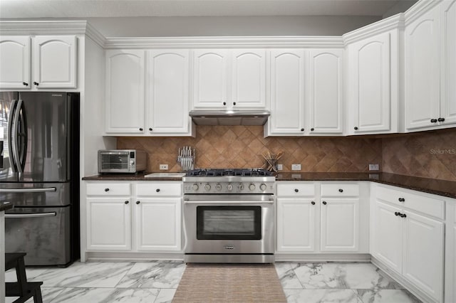 kitchen with marble finish floor, high end stove, ventilation hood, and freestanding refrigerator