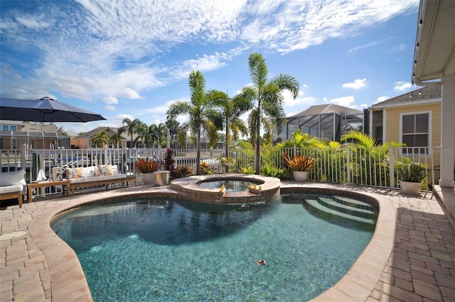 view of swimming pool featuring a patio, fence, and a pool with connected hot tub