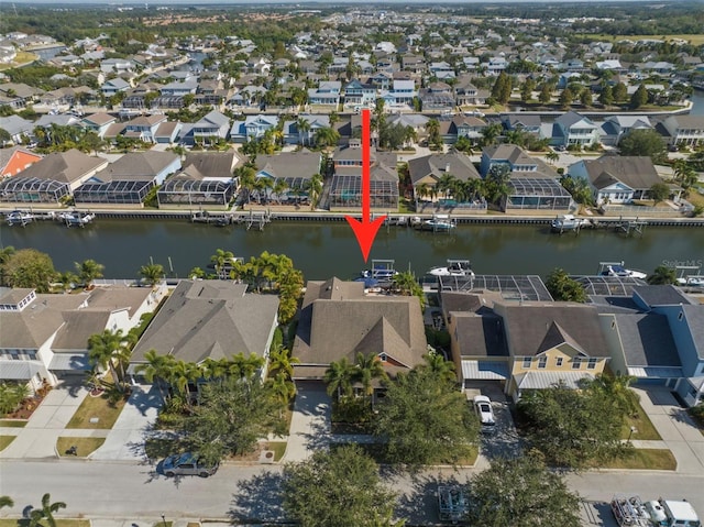 drone / aerial view featuring a residential view and a water view