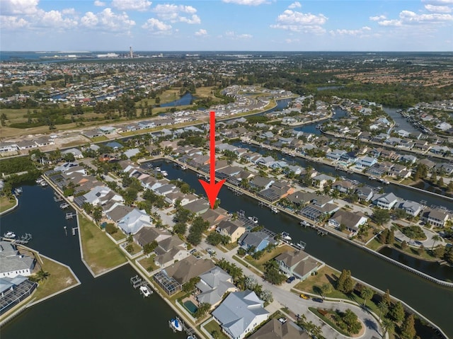 drone / aerial view featuring a residential view and a water view