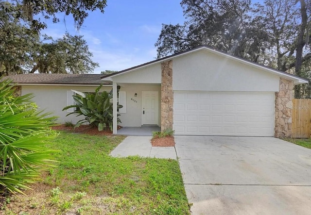 ranch-style home with a garage, concrete driveway, stone siding, and stucco siding