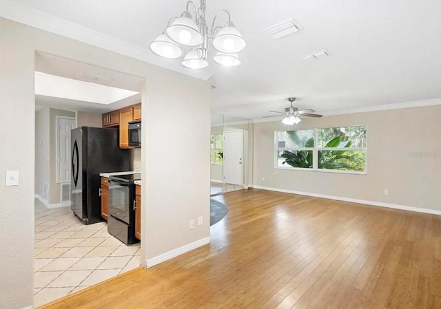 kitchen with black electric range, light wood-style flooring, visible vents, and crown molding