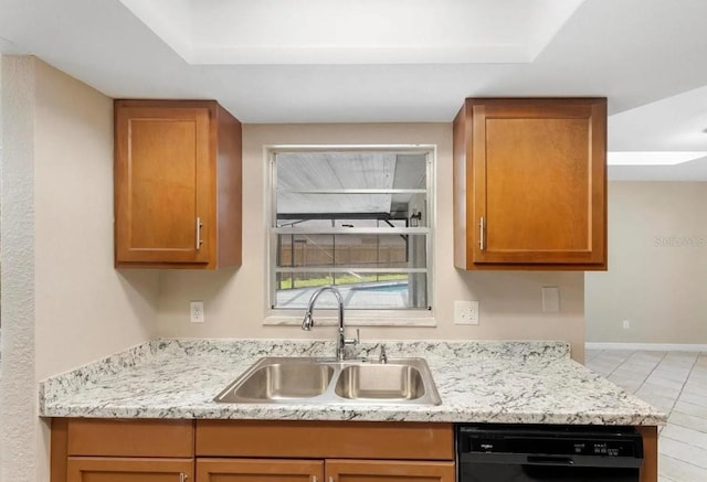 kitchen with light stone counters, a sink, baseboards, dishwasher, and brown cabinetry