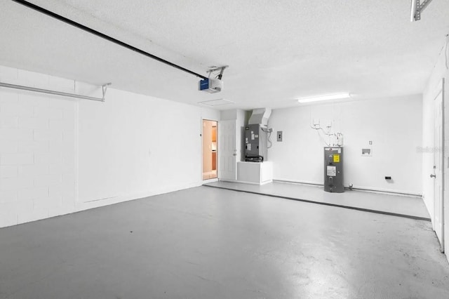 garage featuring a garage door opener, water heater, and heating unit