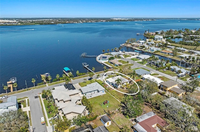 drone / aerial view with a residential view and a water view