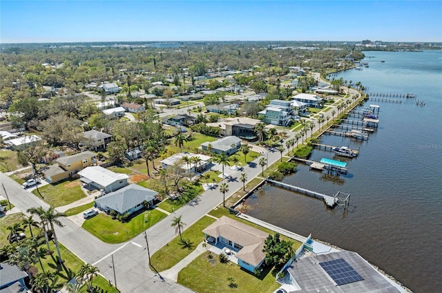 birds eye view of property with a water view and a residential view