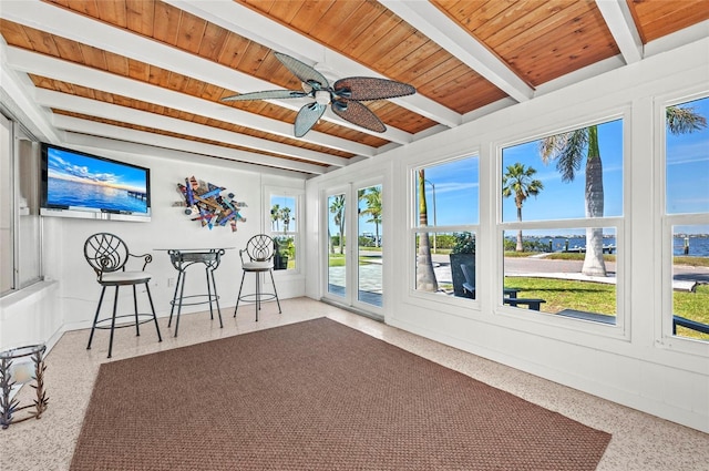 sunroom featuring a ceiling fan, wooden ceiling, and beamed ceiling