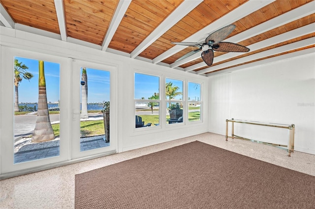 spare room with wood ceiling, ceiling fan, beam ceiling, and speckled floor