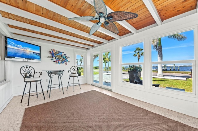 sunroom with beam ceiling, wood ceiling, and a ceiling fan