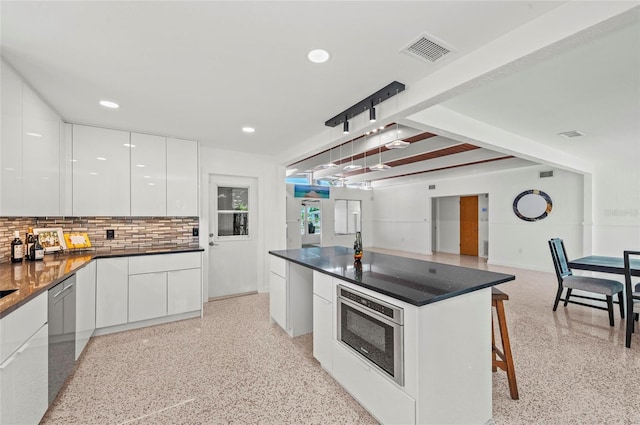 kitchen with visible vents, dishwasher, modern cabinets, oven, and light speckled floor