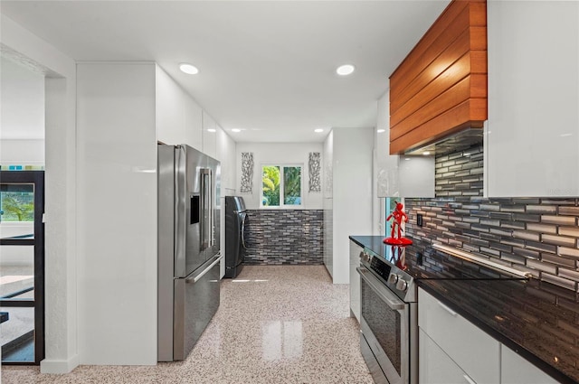 kitchen with light speckled floor, stainless steel appliances, white cabinets, dark countertops, and modern cabinets