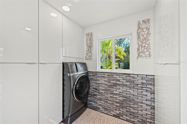 laundry room featuring laundry area and washer / dryer