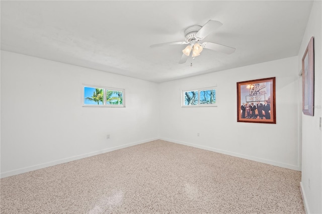 unfurnished room with baseboards and a ceiling fan