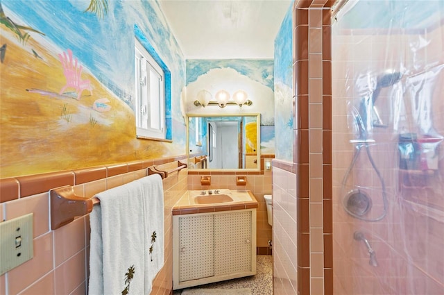 bathroom featuring tile walls, vanity, and walk in shower