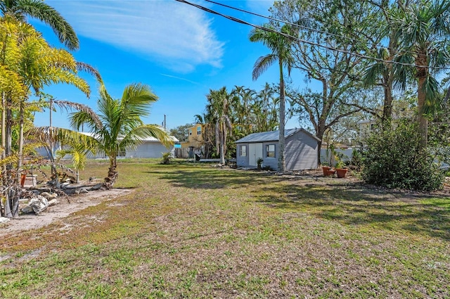 view of yard with an outdoor structure and a storage shed