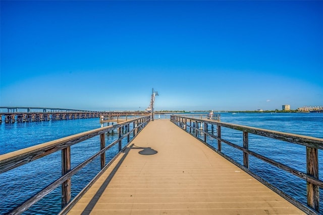 dock area with a pier and a water view