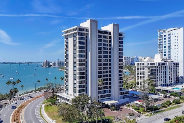 view of building exterior featuring a view of city and a water view