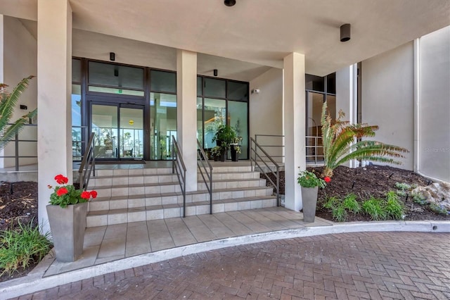 doorway to property featuring stucco siding