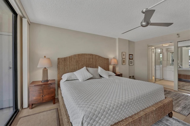 bedroom with ceiling fan, a textured ceiling, and light colored carpet