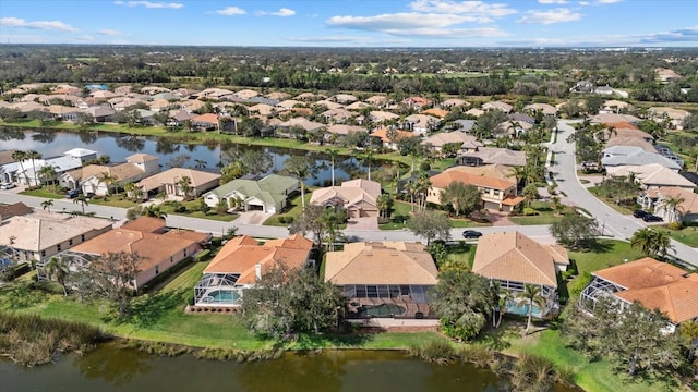 birds eye view of property featuring a water view and a residential view