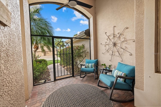 balcony featuring a ceiling fan and a sunroom