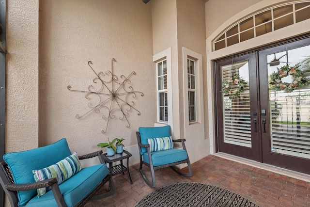 doorway to property featuring stucco siding and french doors