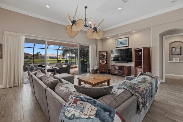 living room with recessed lighting, crown molding, light wood-style flooring, and baseboards