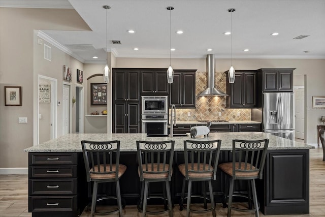 kitchen with wall chimney range hood, visible vents, stainless steel appliances, and crown molding