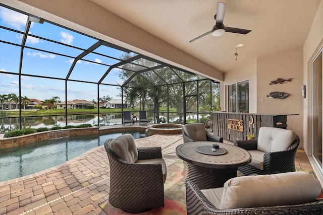 view of patio / terrace with ceiling fan, a lanai, an in ground hot tub, a water view, and an outdoor pool