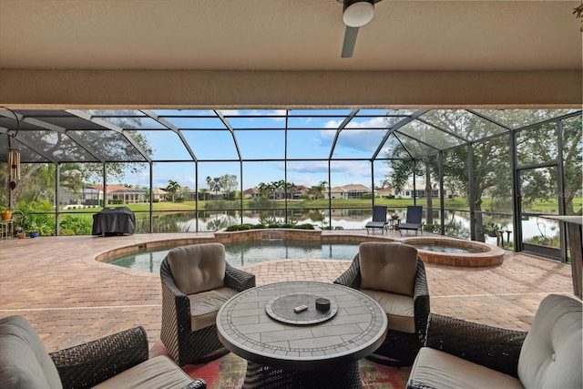 view of patio / terrace featuring a water view, an outdoor pool, a hot tub, and grilling area