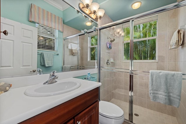 full bathroom with a stall shower, plenty of natural light, and vanity