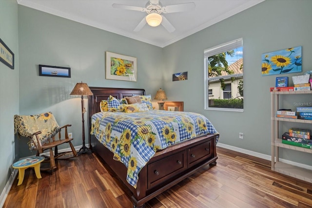 bedroom with ornamental molding, wood finished floors, and baseboards