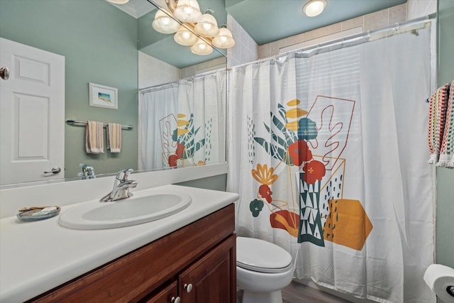 full bathroom with curtained shower, vanity, and toilet