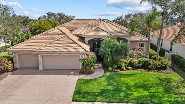 mediterranean / spanish house with a tiled roof, an attached garage, decorative driveway, a front lawn, and stucco siding