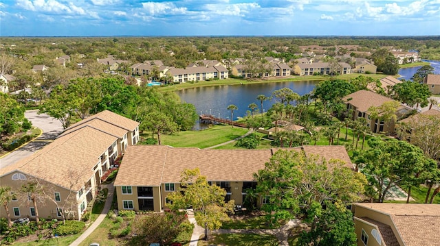 birds eye view of property with a water view and a residential view