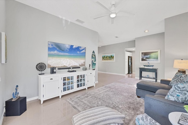 living room featuring visible vents, ceiling fan, and baseboards