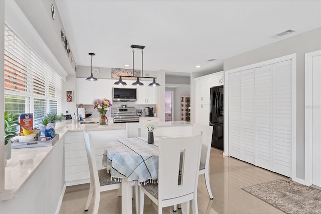 dining space featuring recessed lighting and visible vents