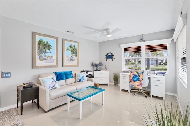 living room featuring a ceiling fan, baseboards, visible vents, and a wealth of natural light