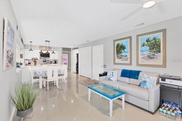 living room featuring visible vents and a ceiling fan