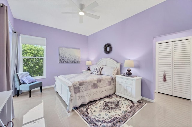 bedroom featuring light tile patterned flooring, baseboards, and ceiling fan