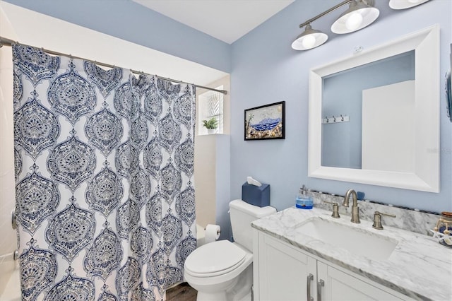 bathroom with vanity, toilet, and a shower with curtain