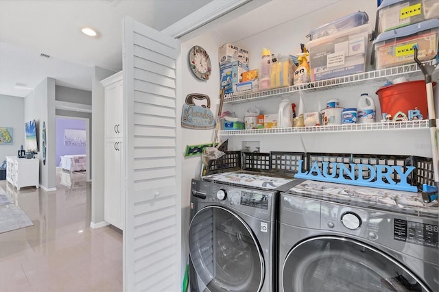 clothes washing area featuring laundry area, baseboards, and separate washer and dryer