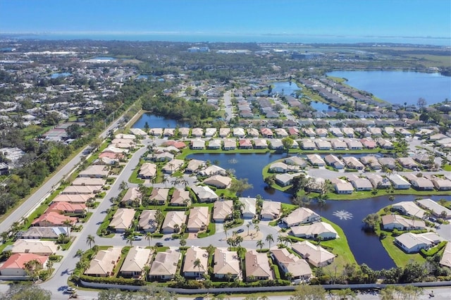 bird's eye view featuring a residential view and a water view