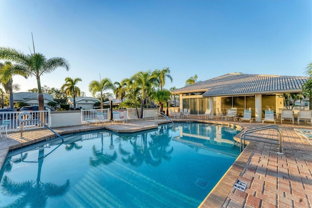 pool featuring a patio area and fence