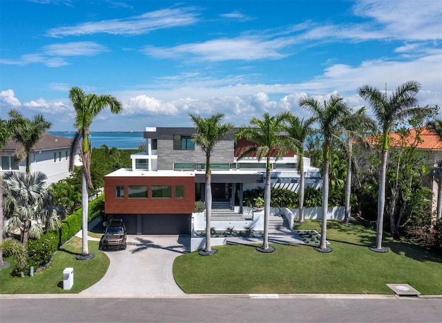 contemporary house with a garage, driveway, and a front yard