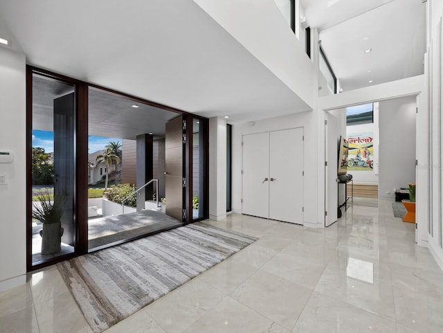 entrance foyer featuring marble finish floor and floor to ceiling windows