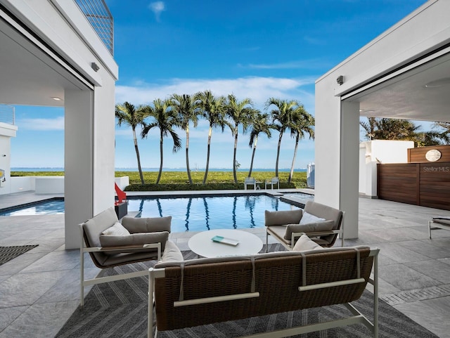 pool featuring a patio area and an outdoor living space