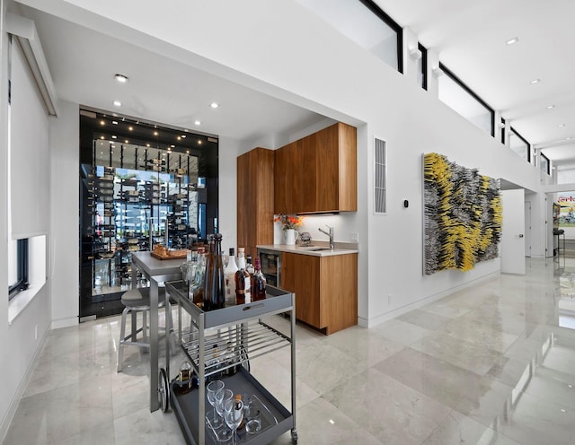 interior space with modern cabinets, baseboards, brown cabinets, and light countertops